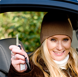 a woman holding up her car keys